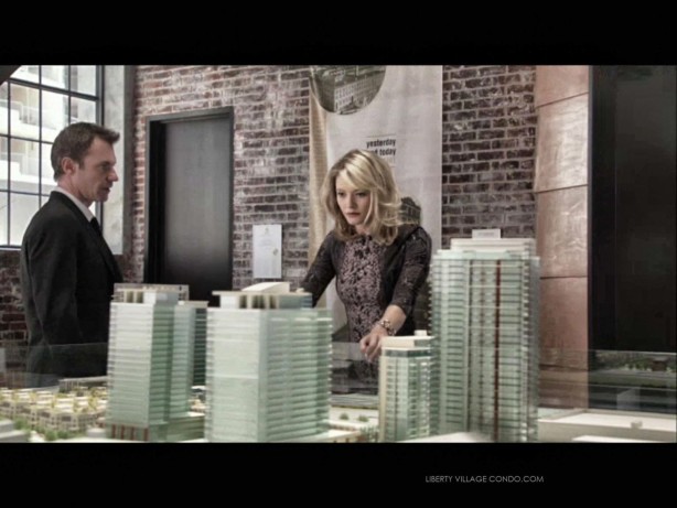 Chris Vance and Sarah Allen in S1 Ep 7 of Transporter in the CanAlfa sales office looking at a scale model of Liberty Village